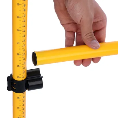 Yellow tube with measuring scale and black holder, hand shows connection between tubes.