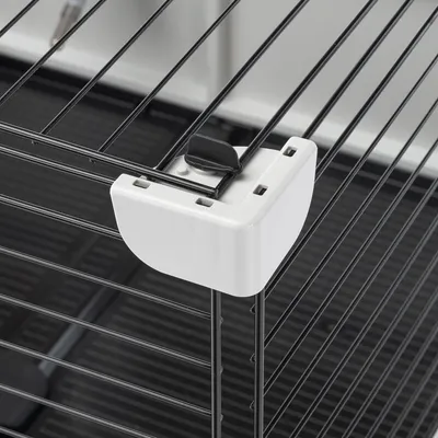 Detailansicht eines weissen Kunststoffverschlusses an einem schwarzen Metallgitter, geeignet für Käfige oder Gehege.