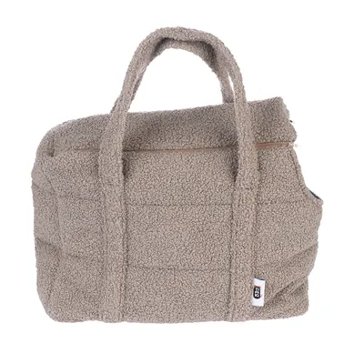 Sac de transport en tissu bouclé beige avec deux anses et fermeture éclair, étiquette visible sur le côté inférieur droit.