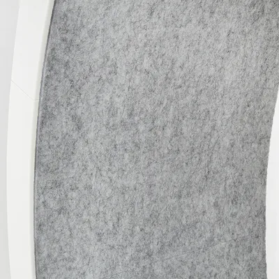 Grey felt surface with white frame, detailed view of a product.
