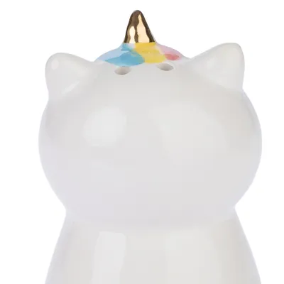 Objet en céramique blanche en forme de chat avec corne dorée et détails colorés sur la tête, deux trous visibles sur le dessus.
