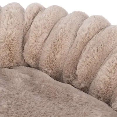 Close-up of beige, fluffy material with soft texture, possibly part of a pet bed or blanket.