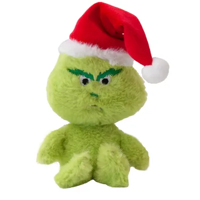 Jouet en peluche verte avec visage brodé, sourcils verts et bonnet de Noël rouge et blanc. Matière : tissu pelucheux.