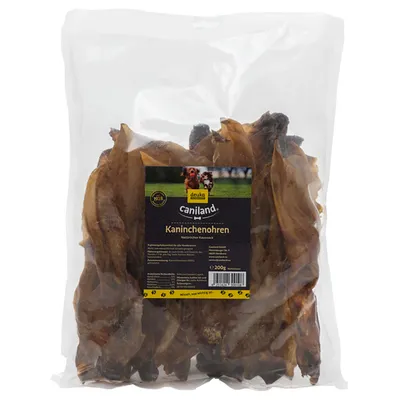 Pose med tørrede kaninører, mærket deuka caniland Kaninchenohren, Natürlicher KauSnack, 200 g. Synlig tekst på tysk om produktinformation og ingredienser.