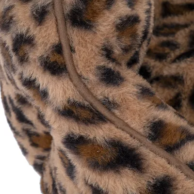 Close-up of brown faux fur material with leopard pattern and a brown seam.