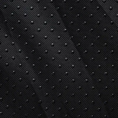 Close-up of a black, non-slip surface with small bumps for better grip.