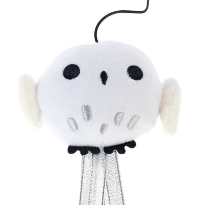 Toy in the shape of a white owl with black eyes, silver accents and a black cable on top. Suitable for interactive play.