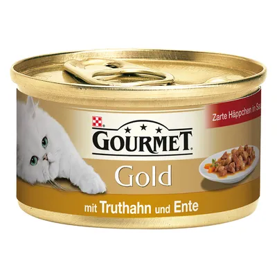 Lata de comida para gato Gourmet Gold, com texto visível: 'mit Truthahn und Ente'. Imagem de um gato branco e prato com pedaços de carne em molho. Texto adicional em alemão.