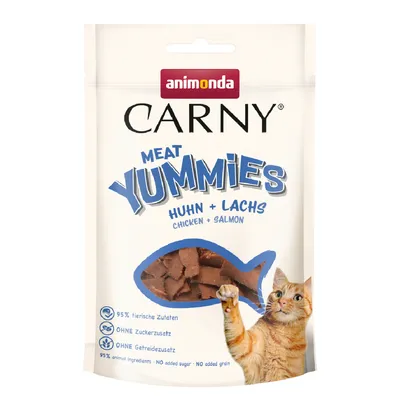 Animonda Carny Meat Yummies pollo e salmone. 95% ingredienti di origine animale, senza zuccheri aggiunti, senza cereali. La confezione mostra snack per gatti e un gatto arancione.