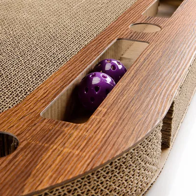 Toy made of wood and cardboard with two purple balls in a compartment. Visible materials: wood look and corrugated cardboard.