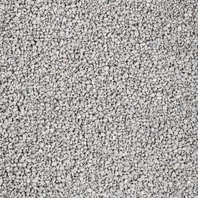 Primer plano de piedras grises finas o granulado, posiblemente arena para gatos.