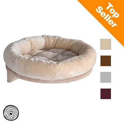Okrągłe, wyściełane legowisko dla zwierząt z drewna z kremowym pokryciem. Kolory: beżowy, brązowy, szary, bordowy. Wskazówka Top Seller w prawym górnym rogu.