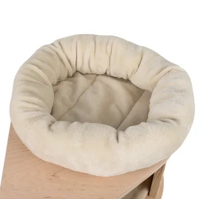 Beige, round cuddly bed made of soft fabric on a wooden platform. Suitable for pets for sleeping or resting.