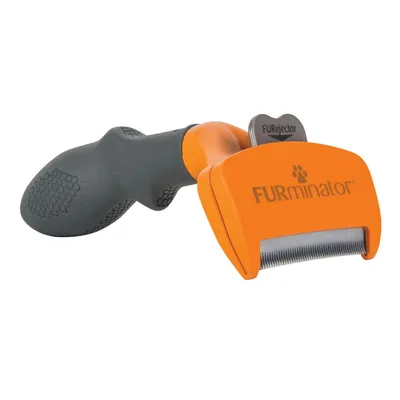 Cepillo con mango negro y cabezal naranja, marca FURminator visible en el cabezal. Botón gris con texto FURjector. Cerdas metálicas visibles.