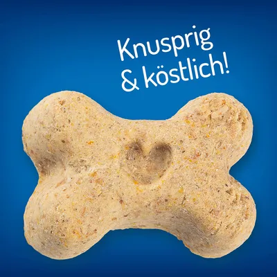 Hundekiks formet som et ben med indgraveret hjerte. Tekst på billedet: Knusprig & köstlich! (tysk tekst).