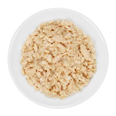 Bowl with shredded, cooked chicken meat. Product image for pet food.