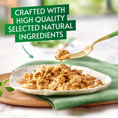 Shredded food served on a plate with text stating crafted with high quality selected natural ingredients.