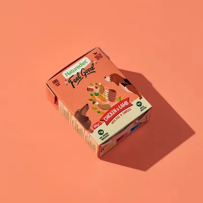 Box labelled 'Chicken & Lamb with Rice & Carrots', showing illustrations of food ingredients and two animals, 390g, grain free, complete meal, suitable for all breeds.