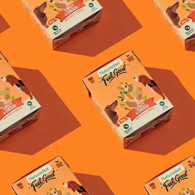 Naturediet Feel Good Turkey & Chicken with Rice & Carrots, 390g pack shown with product name and key ingredients visible on packaging.