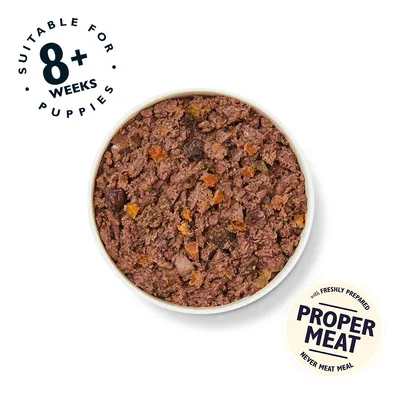 Bowl of wet dog food. Visible text: Suitable for 8+ weeks puppies, with freshly prepared proper meat, never meat meal.