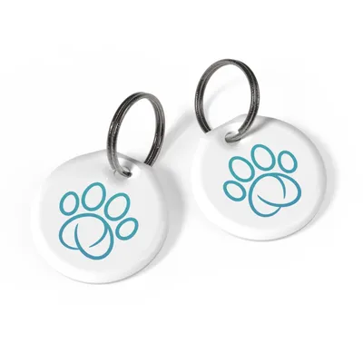 Two round white tags with metal rings, each featuring a blue paw print design.