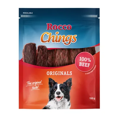 Bolsa de Rocco Chings Originals, 100% beef, 150 g. Imagen de tiras de carne y un perro en el envase. Texto visible: 'The original taste!'. Bolsa de Rocco Chings Originals, 100% beef, 150 g. Imagen de tiras de carne y un perro en el envase. Texto visible: 'The original taste!'.