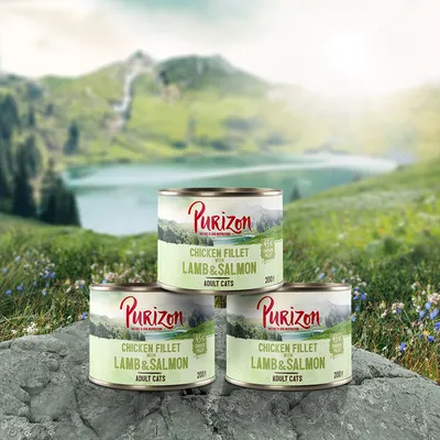 Purizon Chicken Fillet with Lamb & Salmon Adult Cats, 200g tins, 45% chicken fillet visible on label. Three tins shown outdoors with mountain and lake background.