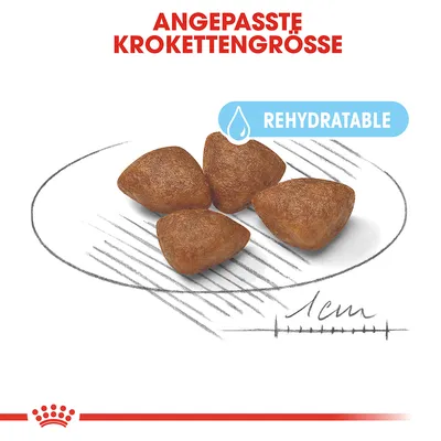 Fire trekantede foderpiller, tekst: ANGEPASSTE KROKETTENGRÖSSE, REHYDRATABLE. Størrelsesangivelse 1 cm vist under pillerne. Tekst på tysk og engelsk.