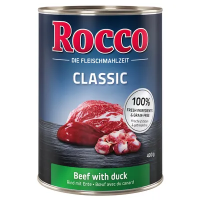 Rocco Classic konzerva 400 g, Beef with duck. Tekst: 100% fresh ingredients & grain-free. Prikaz komada mesa na tamnoj podlozi. Natpisi na engleskom i njemačkom jeziku.