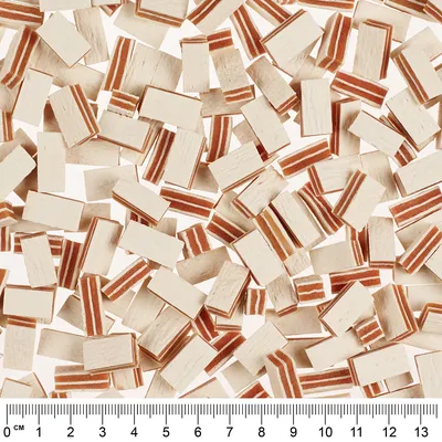 Small rectangular dog snacks with white and red stripes, centimetre scale at the bottom shows size comparison.