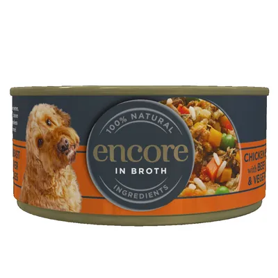 Tin labelled 100% natural ingredients, in broth, chicken with beef and vegetables. Image shows food contents with visible vegetables and grains.