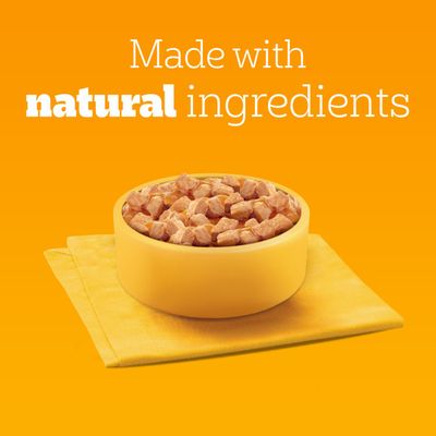 Bowl with food cubes on a yellow napkin, text: Made with natural ingredients.