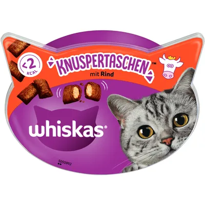 Whiskas Knuspertaschen naudalla, alle 2 kcal per pala. Pakkaus kissanpään muotoinen, harmaan kissan kuva ja välipalan kuva.