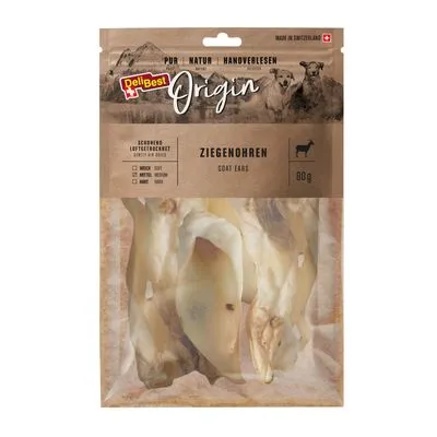 DeliBest Origin Ziegenohren, geitenoren voor honden, 80 g. Verpakking toont gedroogde geitenoren, tekst in Duits en Engels: zacht, medium, hard. Gemaakt in Zwitserland.