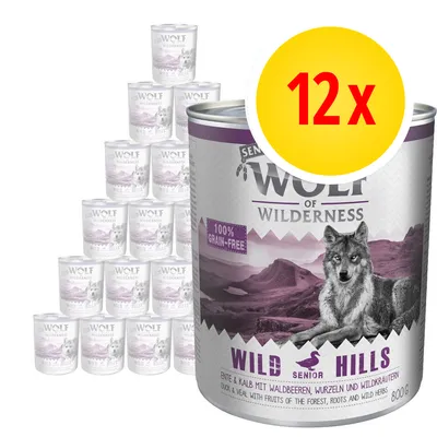 Wolf of Wilderness Senior Wild Hills, 12×800g konzerv. Text: 100% grain-free, duck & veal with fruits of the forest, roots and wild herbs. Velký žlutý kruh s červeným nápisem 12x.