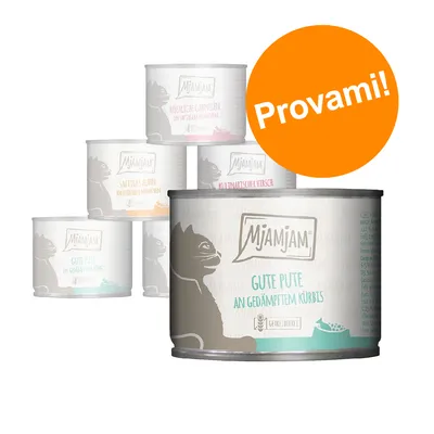 Set di 5 lattine MjAMjAM per gatti, vari gusti visibili in tedesco. Etichetta arancione con testo: Provami!