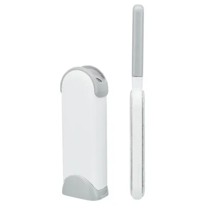 Fusselbürste mit grauem Griff und weisser Reinigungsstation, geeignet zum Entfernen von Tierhaaren von Kleidung und Möbeln. Fusselbürste mit grauem Griff und weisser Reinigungsstation, geeignet zum Entfernen von Tierhaaren von Kleidung und Möbeln.