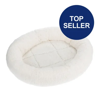 Weißes, ovales Haustierbett aus weichem Material mit blauem Kreis und Text 'Top Seller'.