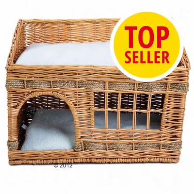 Cuccia a due piani in vimini con cuscini bianchi visibili, badge giallo con testo rosso 'TOP SELLER' in alto a destra.