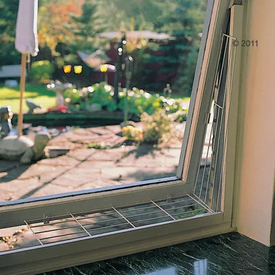 Fensterschutzgitter aus Metall, montiert an einem geöffneten Fenster. Schutz vor Durchfallen oder Ausbruch für Haustiere.