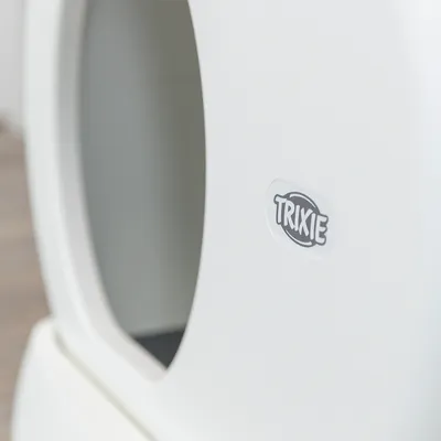 Logo de Trixie en carcasa de producto blanca, recorte ovalado visible.