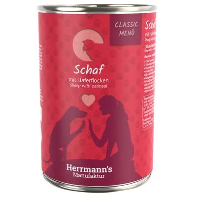 Herrmann's Manufaktur CLASSIC MENÜ Schaf mit Haferflocken, tekst in Duits en Engels: Sheep with oatmeal. Illustratie van hond en persoon met hartje.