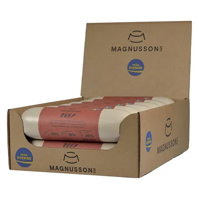Magnussons Beef dog food rolls in open cardboard box, visible text: 'Beef', 'Meat 65%', 'Organs 15%', 'Vegetables 20%', 'Från Sverige', Swedish flag on label.
