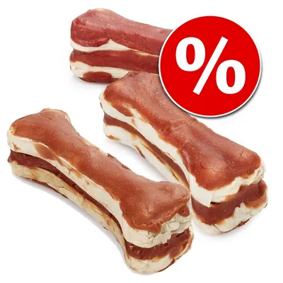 Kości do żucia z czerwono-białymi warstwami, obok czerwone kółko z symbolem procenta – oferta promocyjna na przysmaki dla zwierząt widoczna na zdjęciu. Kości do żucia z czerwono-białymi warstwami, obok czerwone kółko z symbolem procenta – oferta promocyjna na przysmaki dla zwierząt widoczna na zdjęciu.
