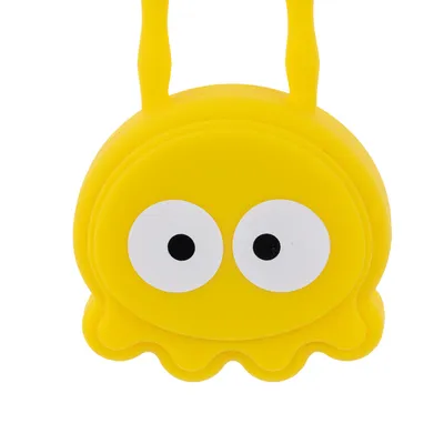 Gelbes Spielzeug in Form eines Cartoon-Monsters mit grossen weissen Augen und zwei Griffen oben. Gelbes Spielzeug in Form eines Cartoon-Monsters mit grossen weissen Augen und zwei Griffen oben.