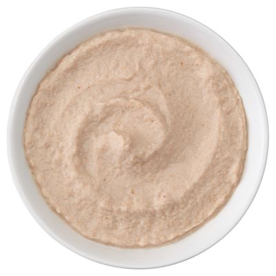 Närbild av en skål med krämig, beige konsistens. Produktbild visar innehållets textur.