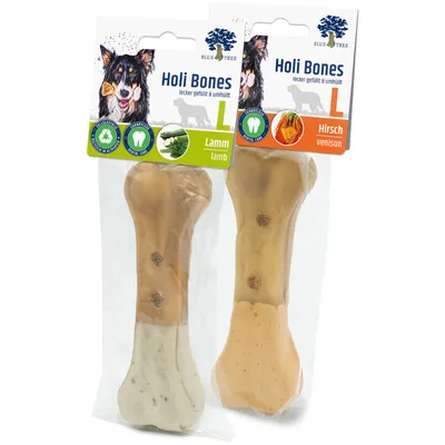 Deux os à mâcher Blue Tree Holi Bones L, saveurs Lamm (agneau) et Hirsch (cerf), emballés individuellement. Icônes recyclage et soin dentaire visibles sur l’emballage.