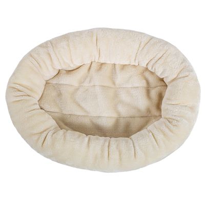 Oval-shaped, cream-coloured plush pet bed with raised padded sides and a soft inner surface, shown from above.