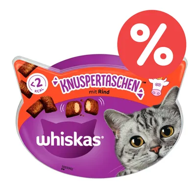 Envase de snacks para gatos Whiskas Knuspertaschen mit Rind, menos de 2 kcal por unidad, imagen de vaca y símbolo de porcentaje en rojo.
