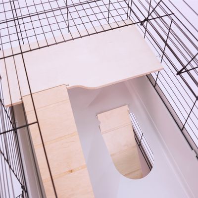 Holzplattform mit Rampe in einem Metallkäfig, geeignet für Kleintiere. Sichtbare Materialien: Holz und Metall.